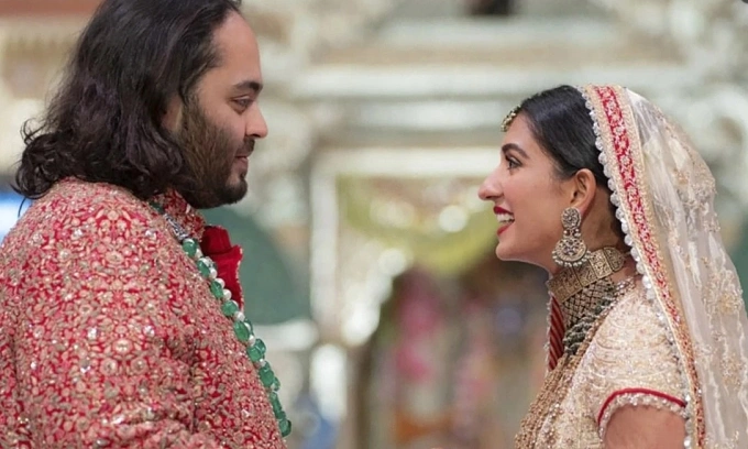 Anant Ambani, left, the son of billionaire Mukesh Ambani, holds hands with Radhika Merchant during their wedding ceremony at Jio World Convention Centre in Mumbai. Photo by AP.