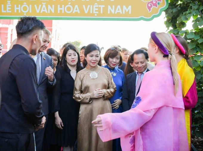 Phu nhân Tổng bí thư Tô Lâm - bà Ngô Phương Ly (giữa) - giới thiệu vẻ đẹp của văn hóa Việt qua tà áo dài của nhà thiết kế Vũ Việt Hà (trái) trước bạn bè quốc tế. Ảnh: Ban tổ chức cung cấp